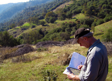 Volunteer Karl Mertz checking the map while monitoring at Oest Ranch Lake Clementine Preserve.