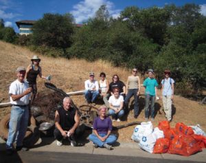 PLT volunteers pose with trash they removed from Sierra Canyon Creek.