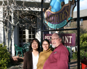 Mehrey Vaghti, PLT’s art event chairperson, stands in the middle of Pat & Pete Enochs, owners of Latitudes Restaurant in Auburn.