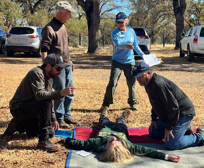 Instructor Cathy Scott sets up a bike accident scenario for trainees to put their skills into real-time practice.