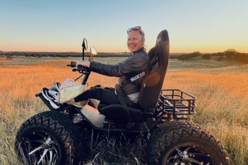 A person using an off-road mobility device in an open field