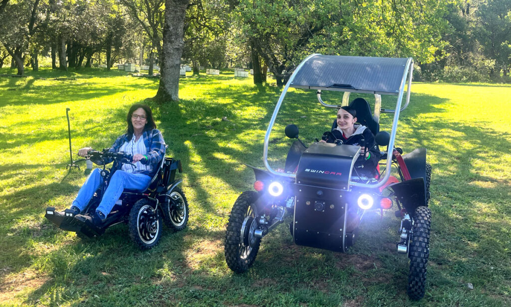 Participants test out mobility devices on a grassy meadow